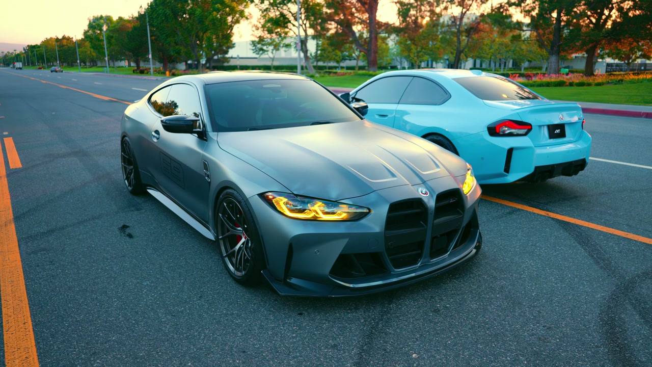 Two BMWs composed together on a sunlit street